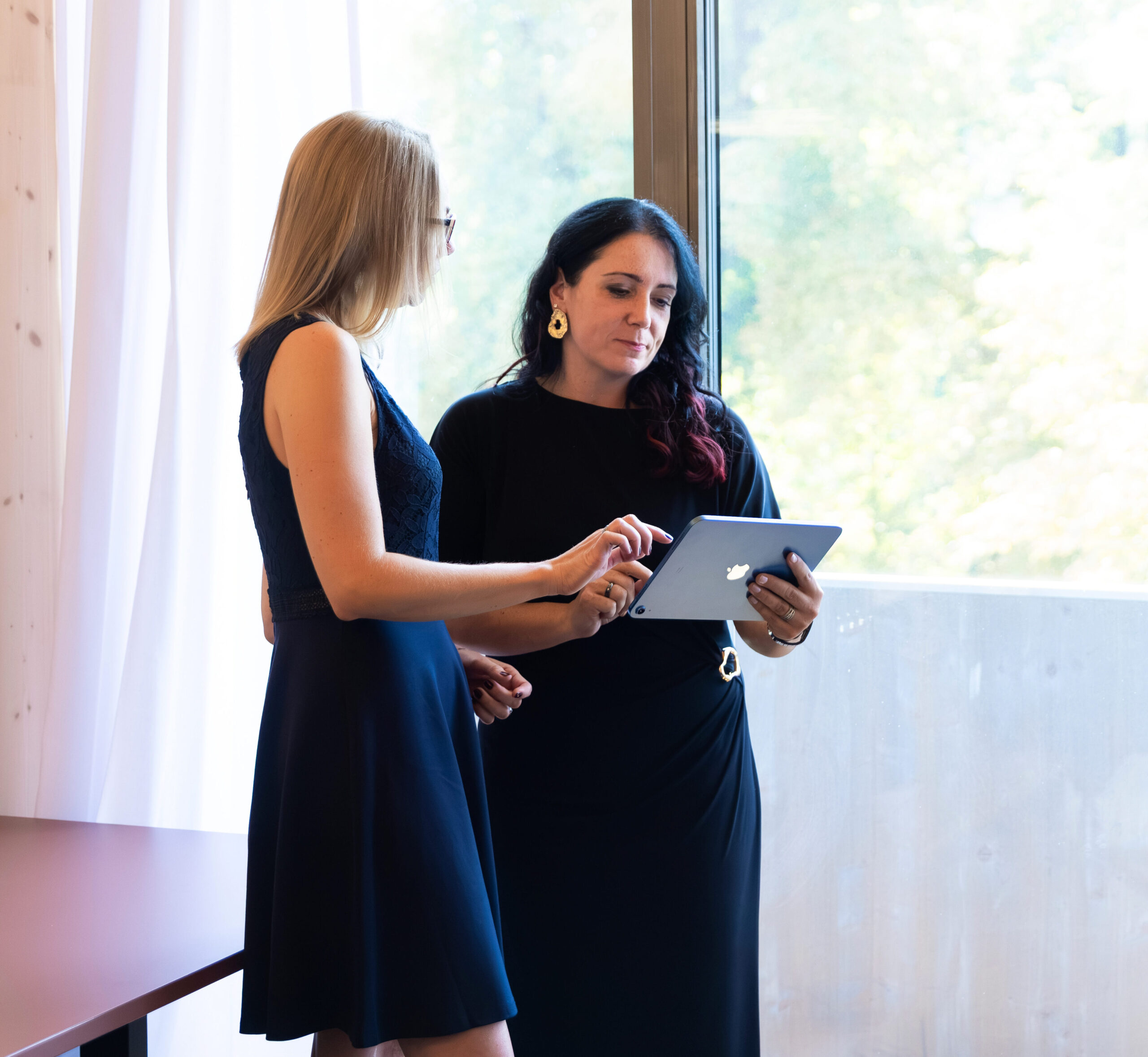Two women discussing results on a tablet